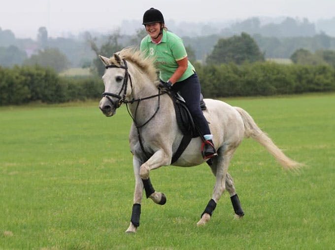 Vicky Stacey riding a white horse